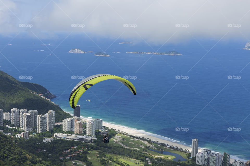 Paraglider flying over Sao Conrrado in Rio de Janeiro Brazil.