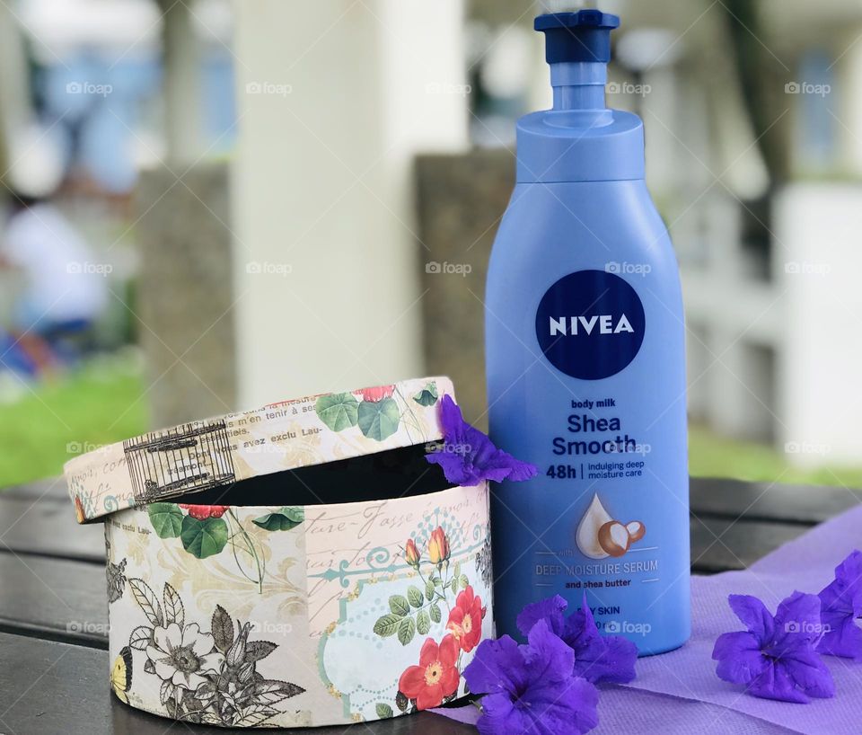 Nivea shea smooth body lotion with gift box and lavender flowers.