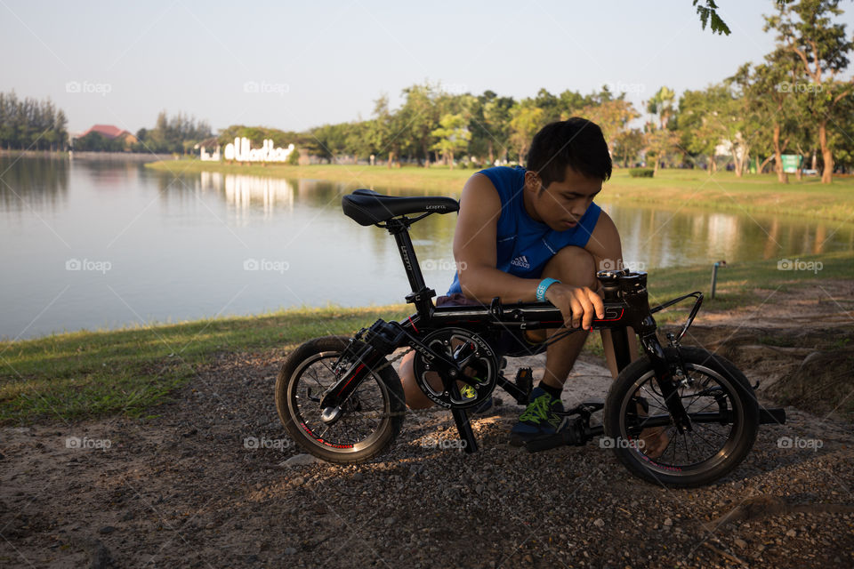 Man fixing bike in the park 