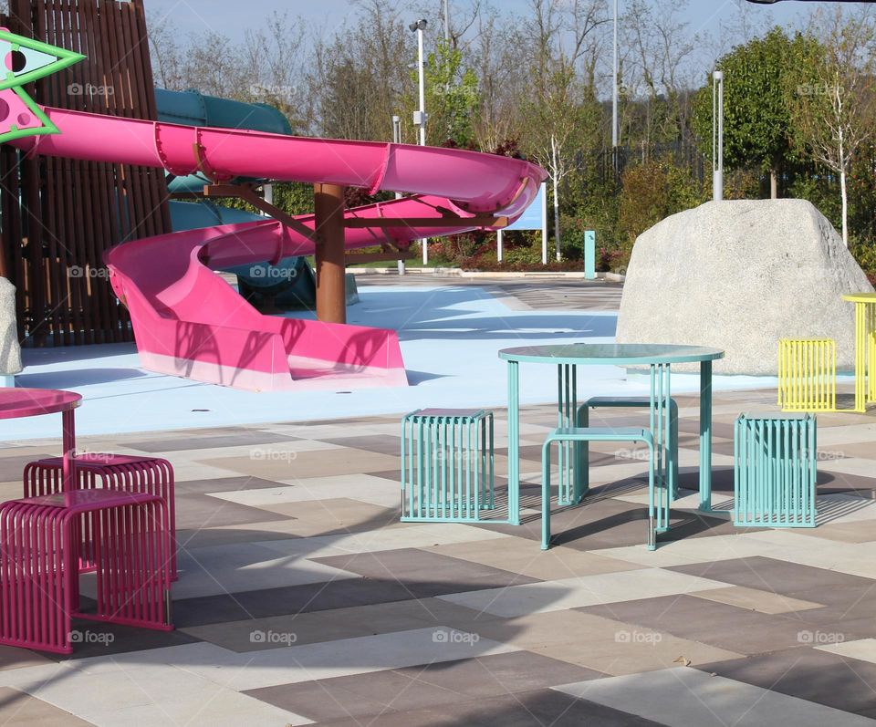 Outdoor children's playground in bright colors: pink,  yellow and blue.  Barbie style