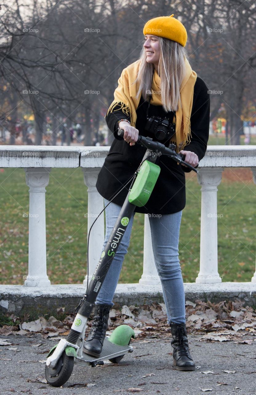 Young woman on the scooter in the park