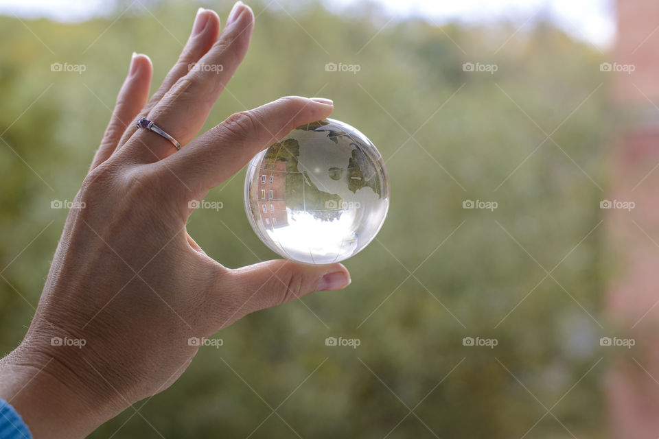 transparent globe in hand