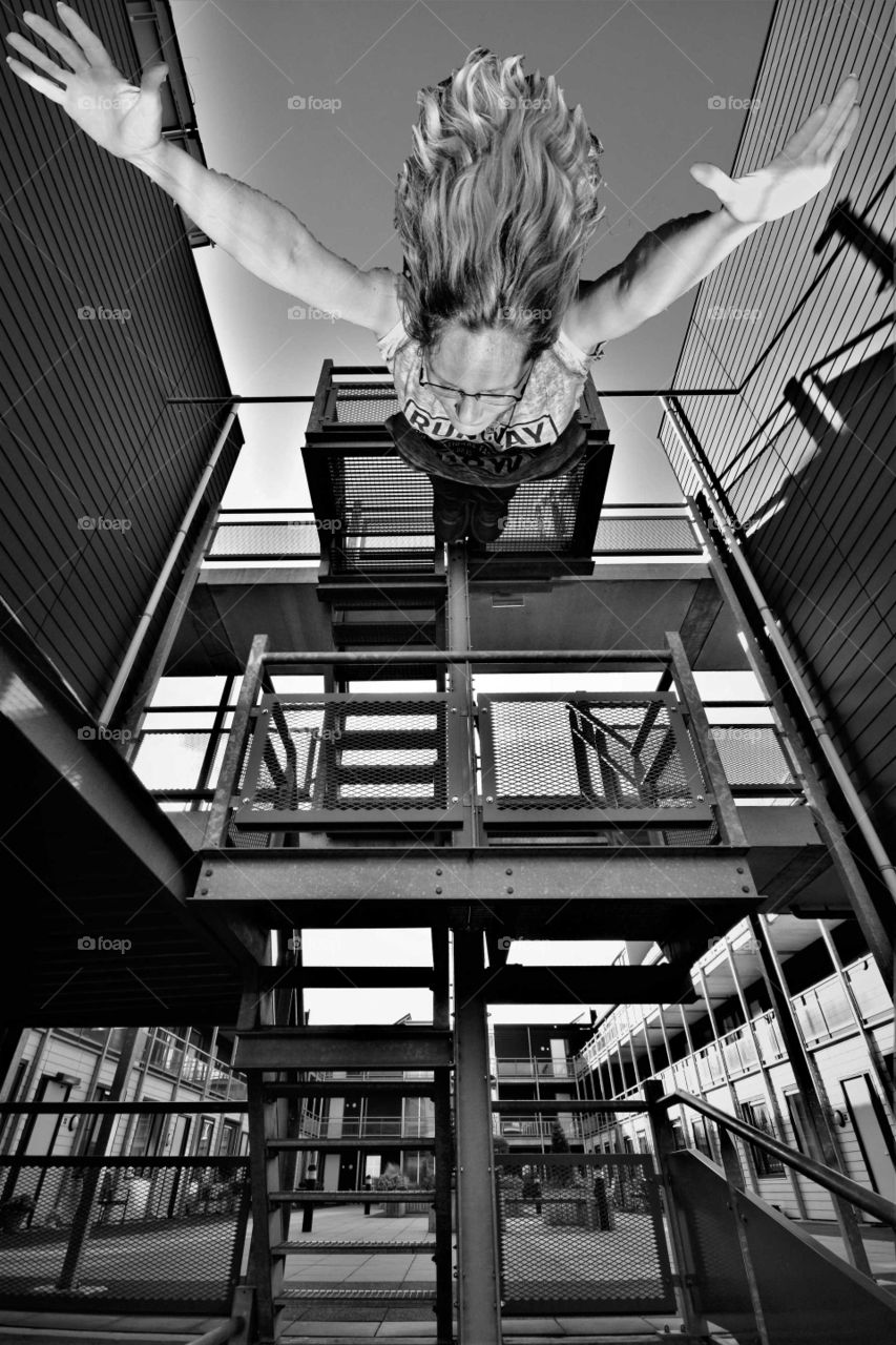 woman jumping from high building black and white perspective picture