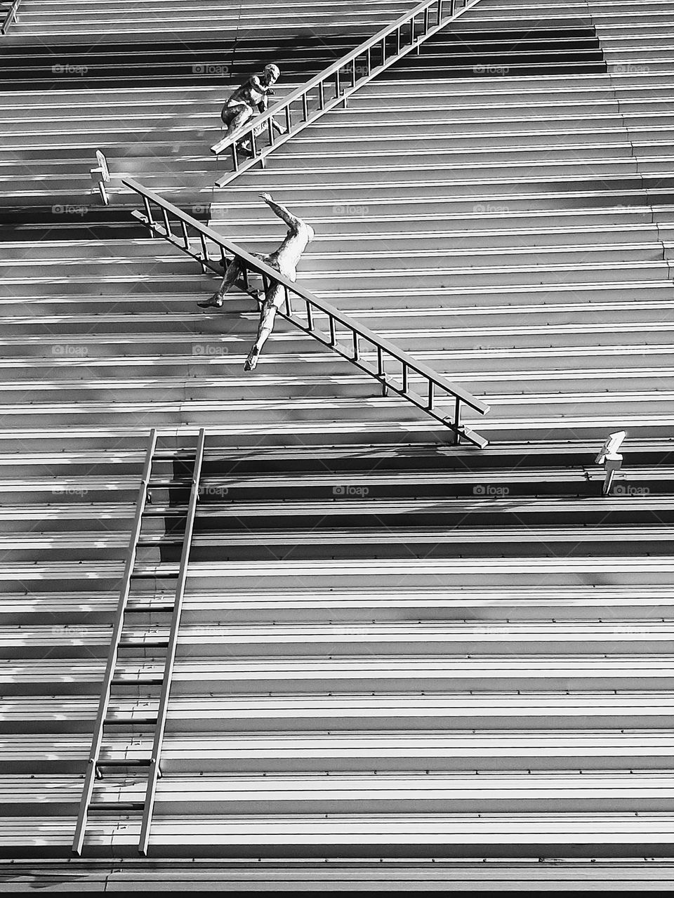 Sculpture at side building in metal representing workers.
