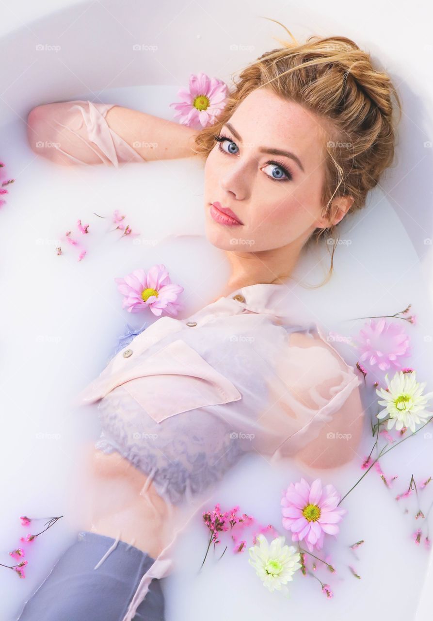 Attractive woman lying on bathtub