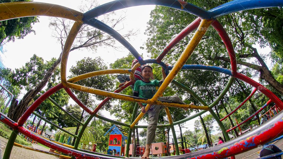 children playing round metal climbing on the playground