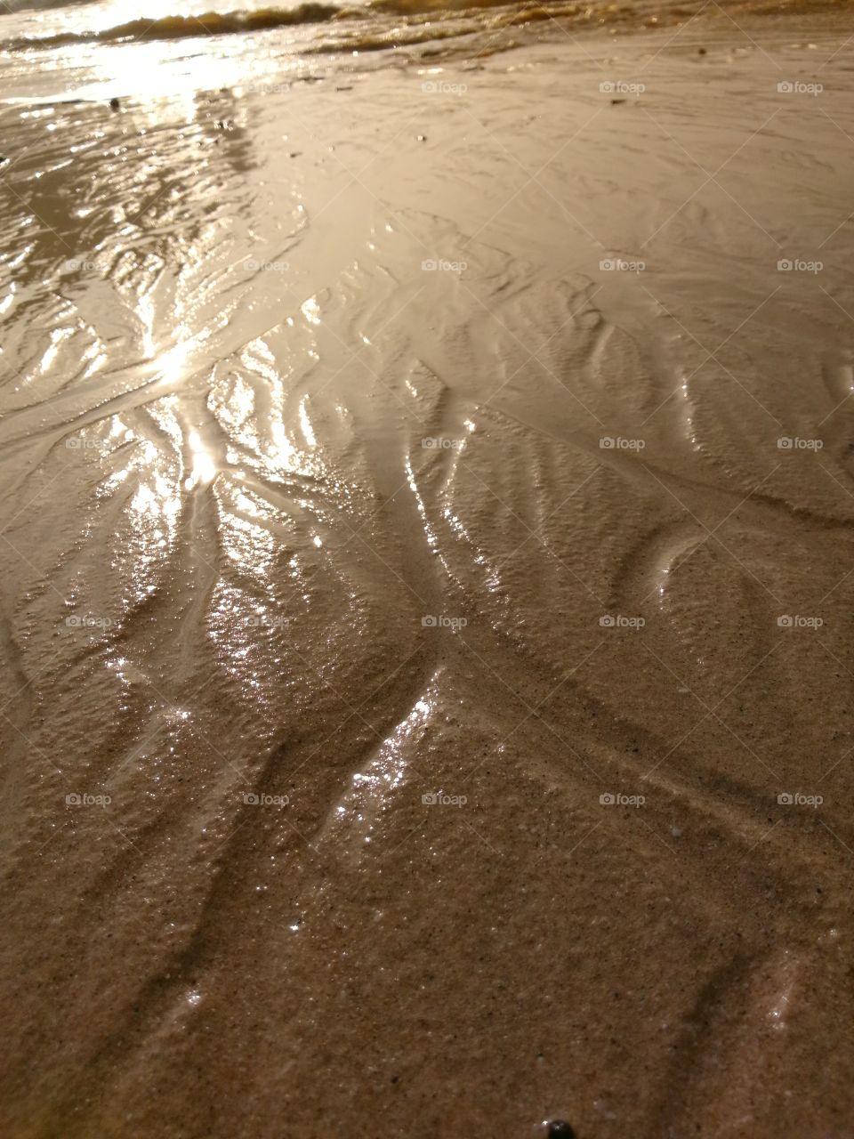 Wet sand with patterns on a beach in Thailand