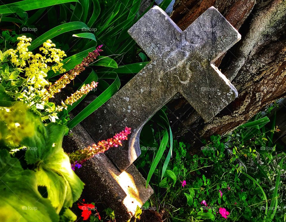 Stone cross and flowers—taken in Ludington, Michigan 