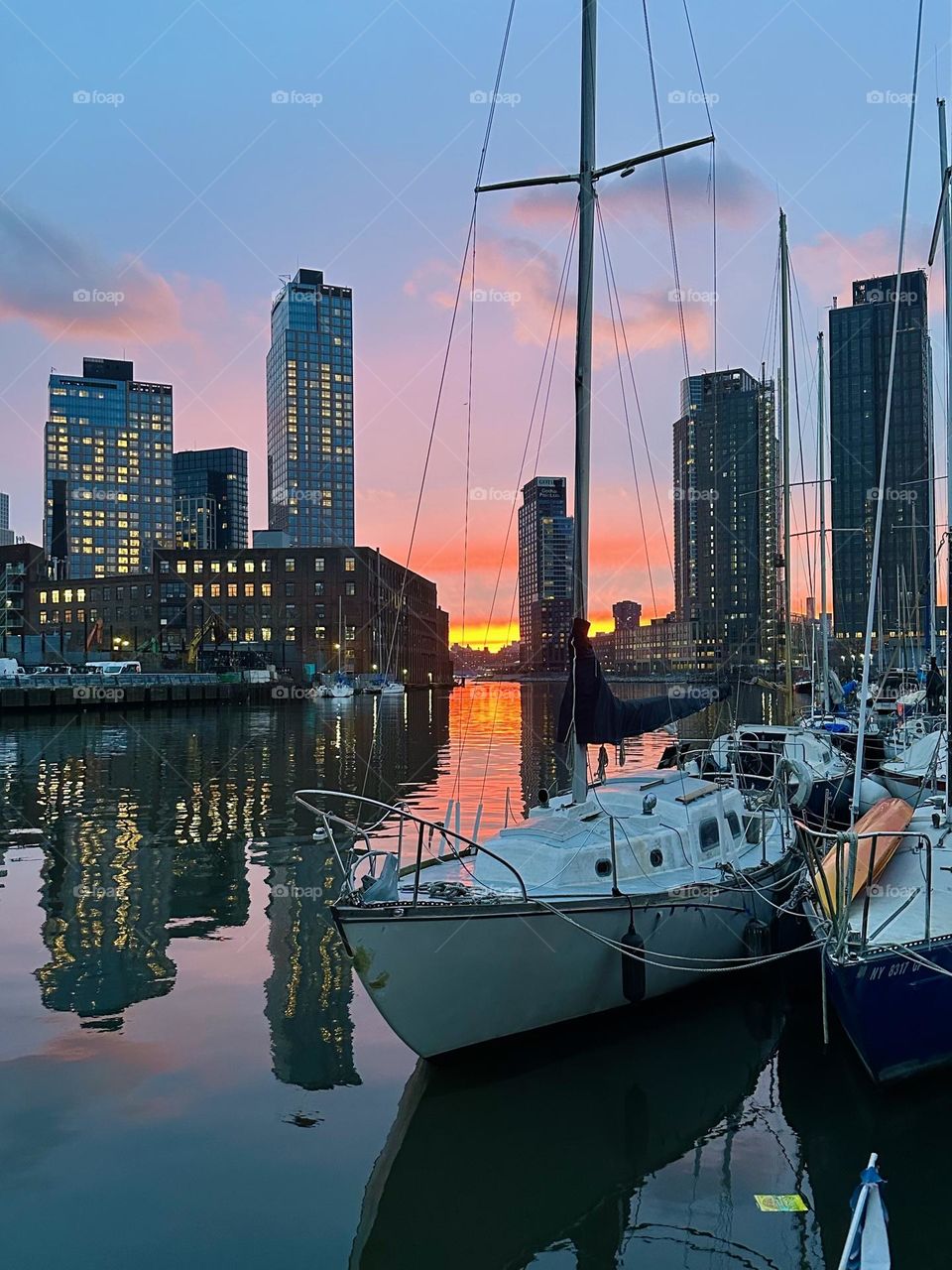 This is beautiful “Newtown Creek” by the “Pulaski Bridge” in LIC at sunset before nightfall seen from the front deck of “Salvation”, the “28 ft 1969 Luhrs” cabin cruiser that is home to myself and partner “Timothy Trespas”. 2024. Hypnotic Productions