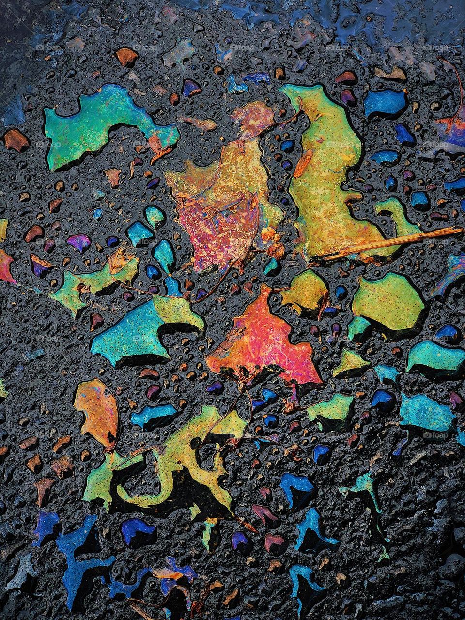 Oil and water in the parking lot, spills in the parking lot, parking lot pretty, rainbow of colors 