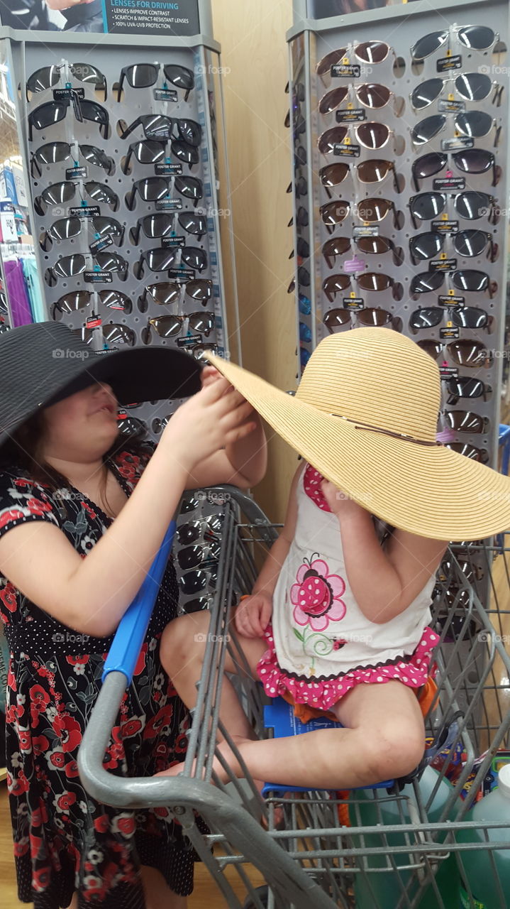 girls playing in hats