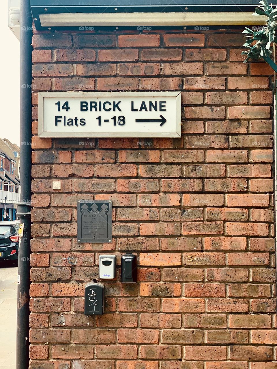 Rectangular red bricks covered wall in a residential quarter of London, 14 brick lane 