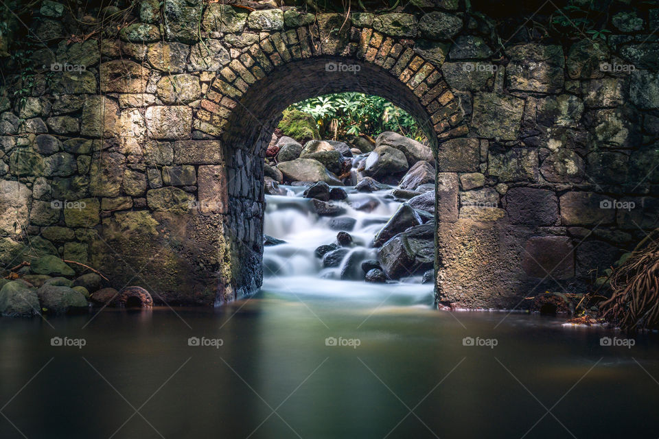 Flowing water transformed into a calm stillness. The tunnel and flowing water represents a sense of tranquility