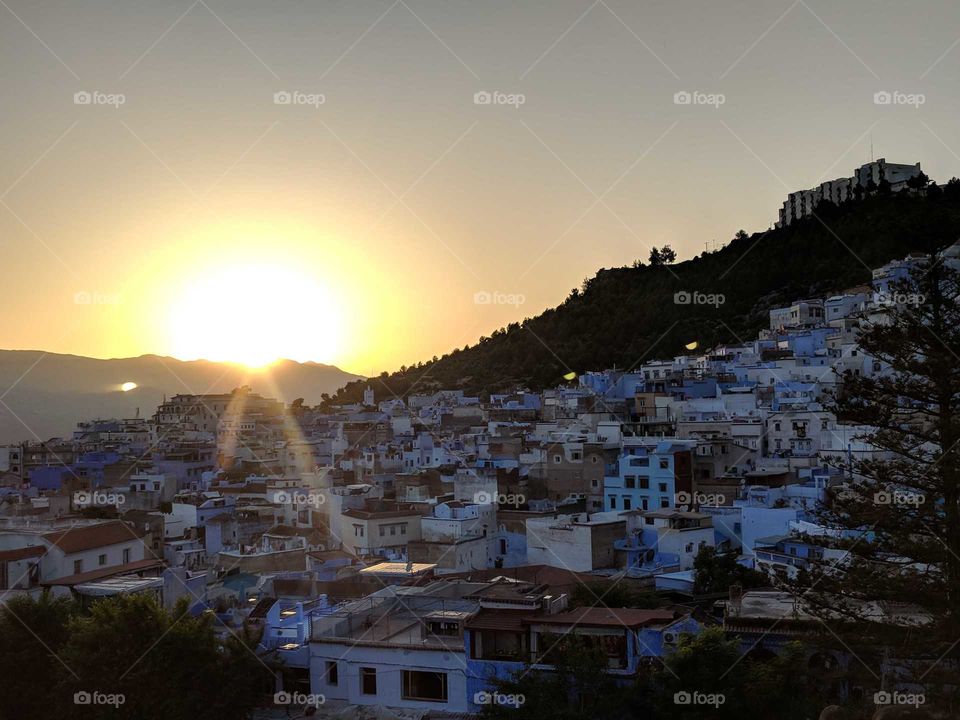 Sunset over Chefchaouen (the Blue City) in Morocco - View from High Up Above (Hike) over Blue Building on a Hill Side in the Mountains
