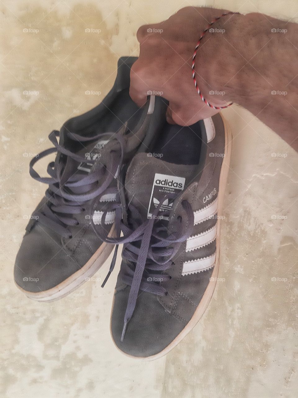 A pair of grey Adidas shoes