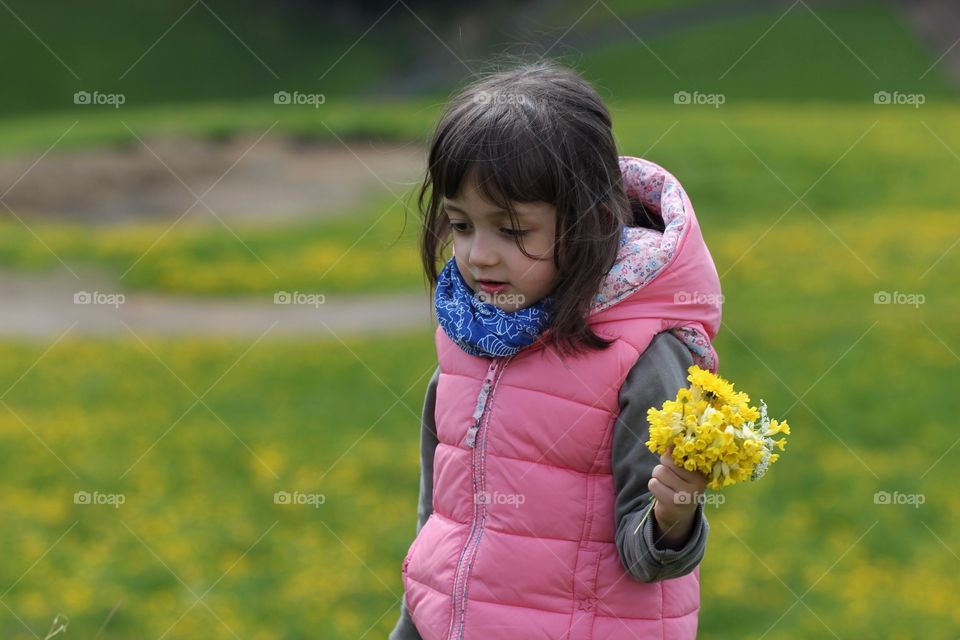 Child with yellow flowers 