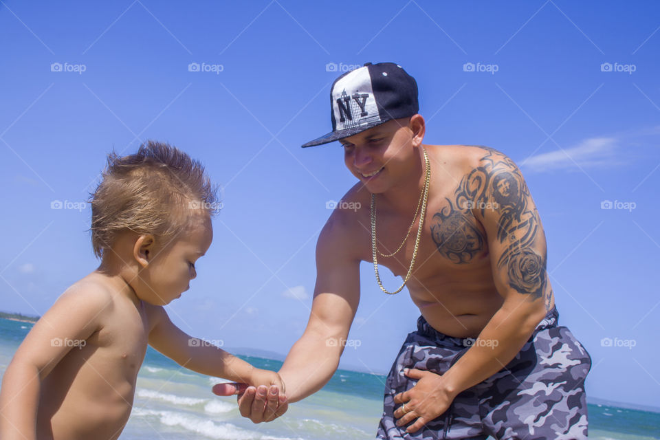 Father and son playing in the beach