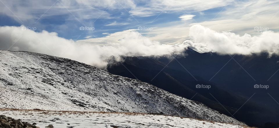 Snowy hill with clouds
