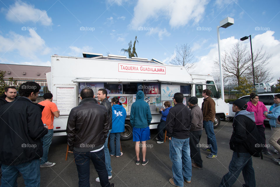 People waiting to buy taco