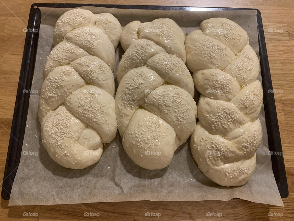 Homemade braided dough for Chala bread just before oven with sesame on top