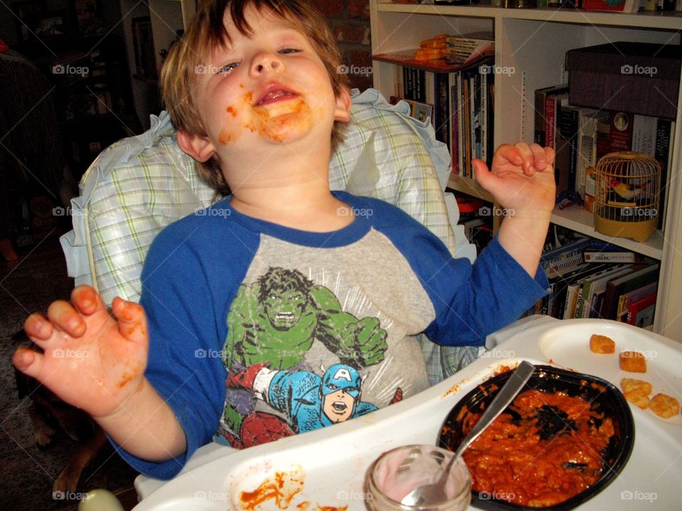 Young Boy Making A Mess With His Food
