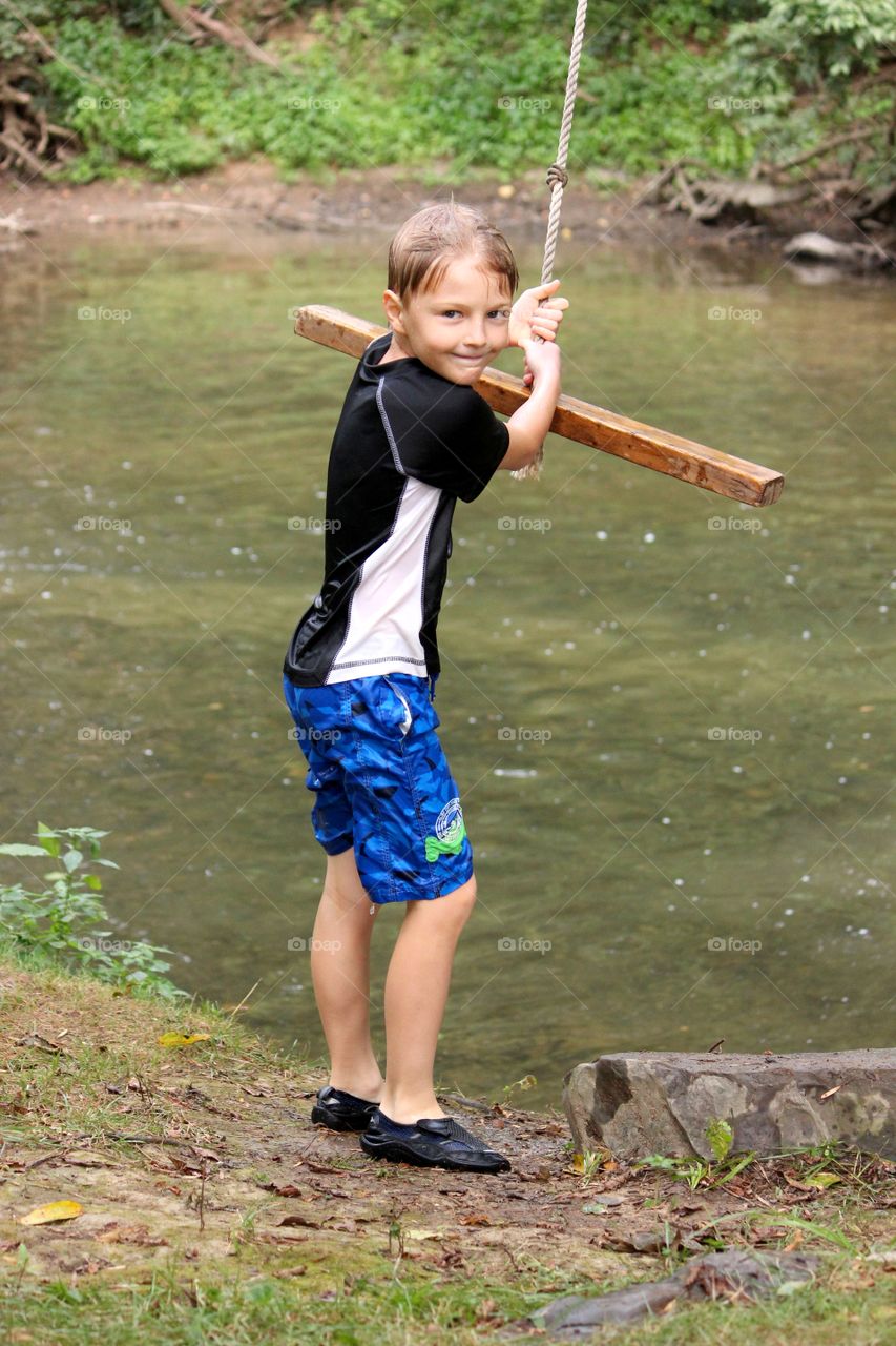 Boy holding rope swing