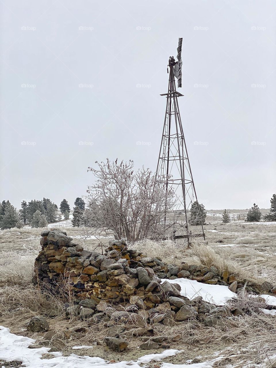 Old Root Cellar next to abandoned Windmill in rural Eastern Washington farm country.