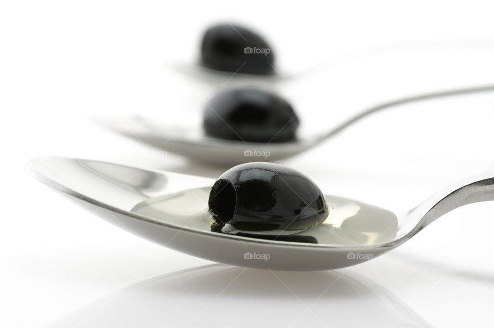Elegant composition with olives on spoons