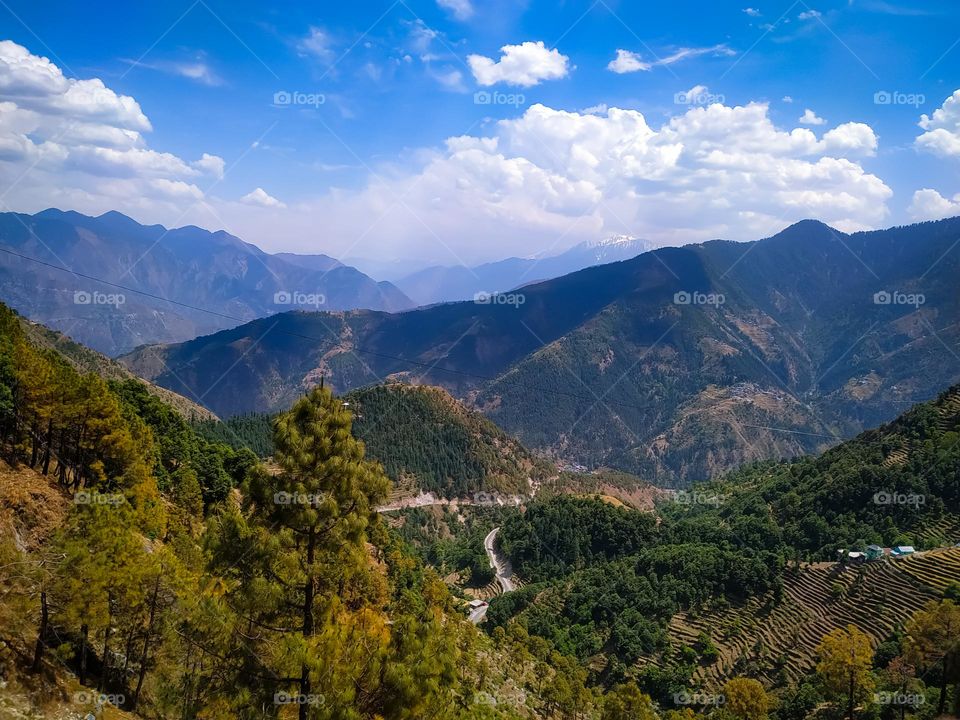 A amazing view of the mountains from above with sky and clouds