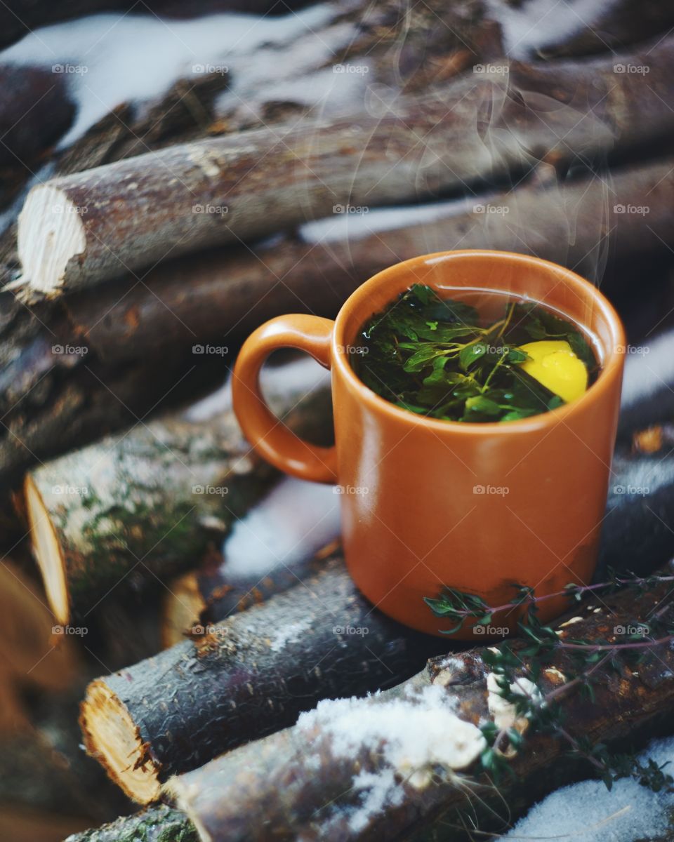 Hot water with holy leafs and slice of lemon