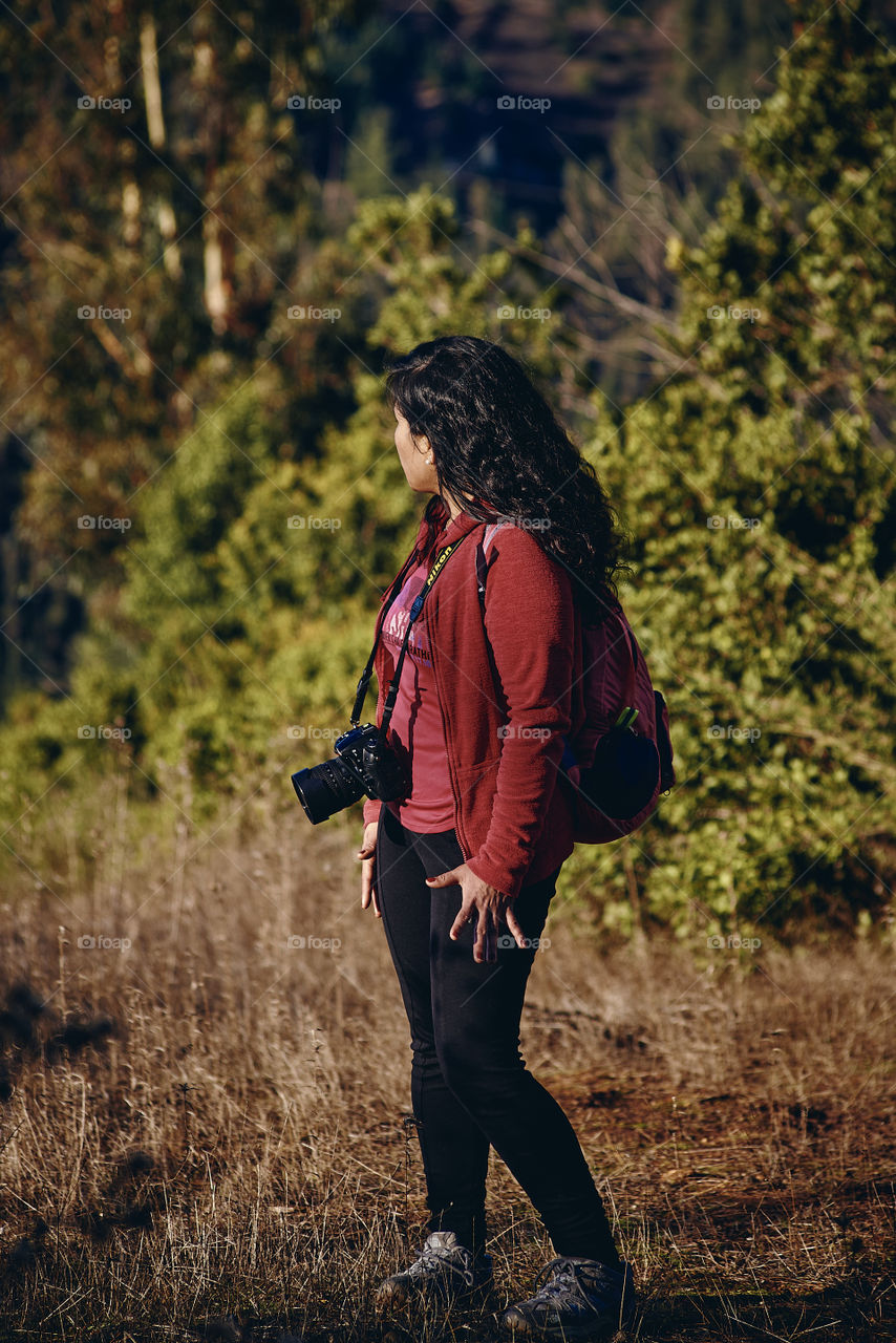 Woman with camera visiting the countryside