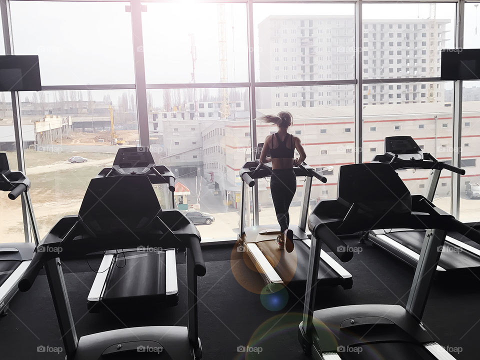 Young woman running in the gym 