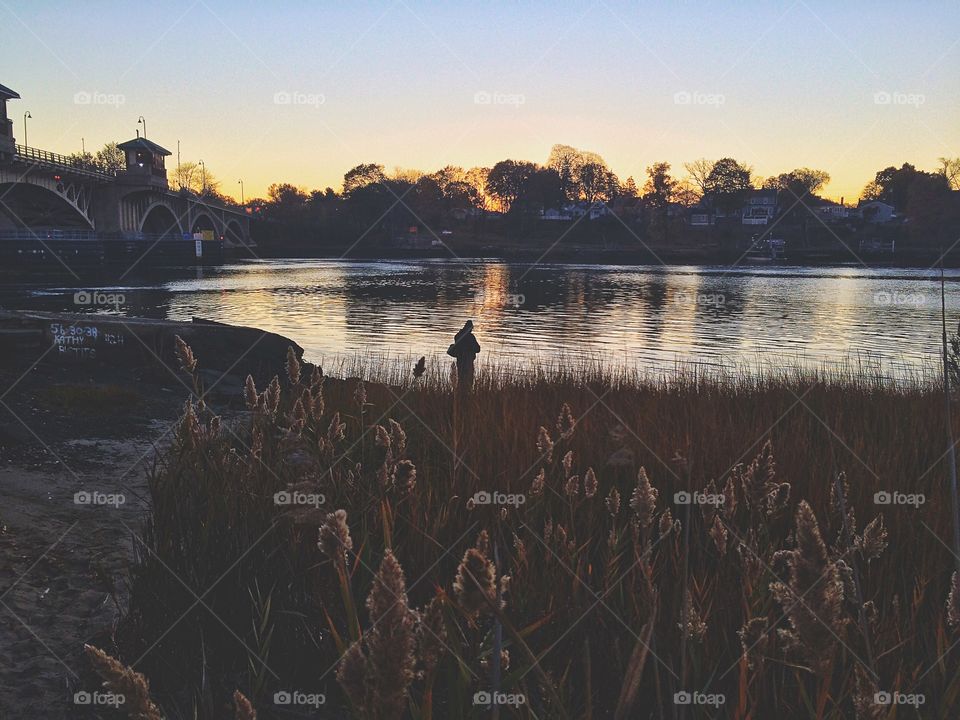 Person standing near lake