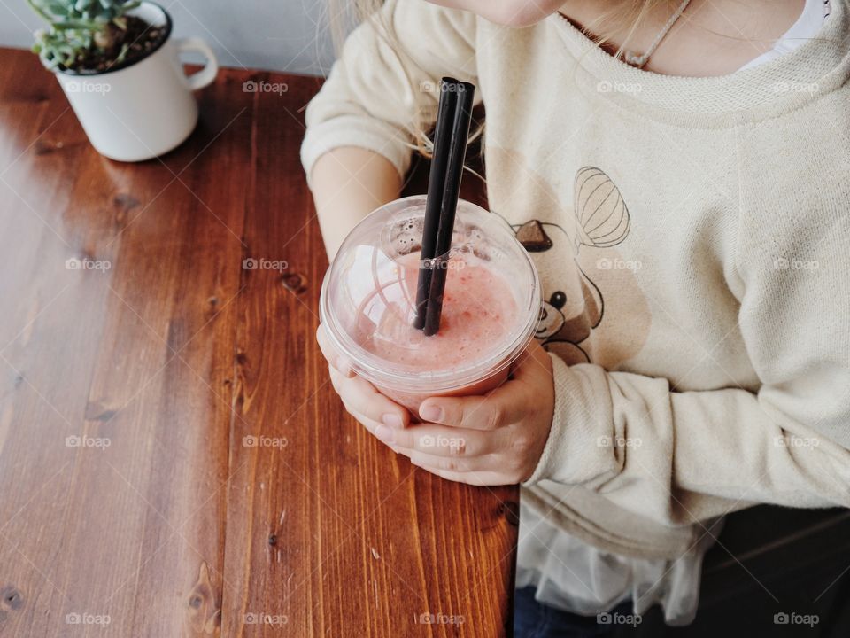 Little kid and her smoothie 