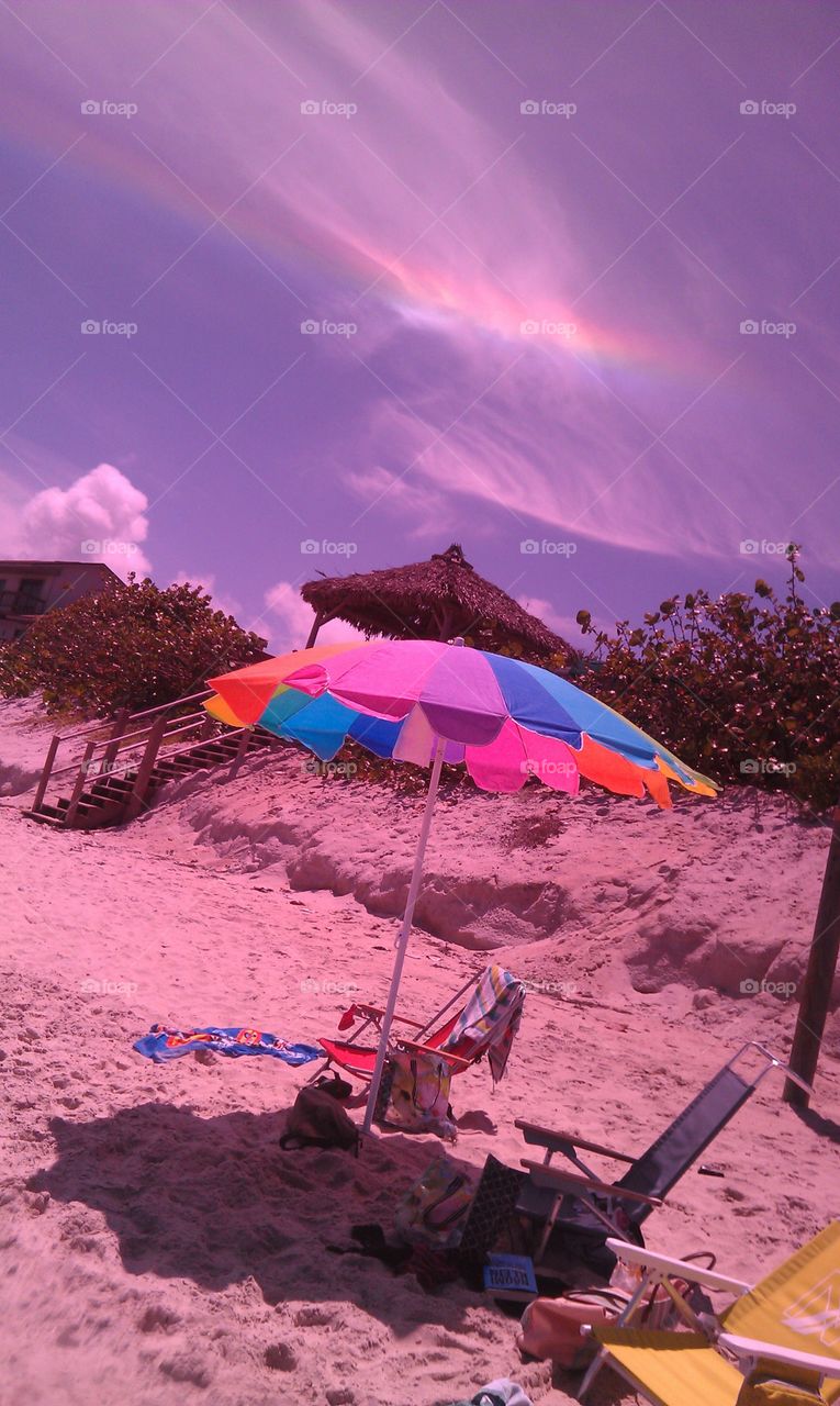 Colorful Sky. Visible spectrum over beach umbrella