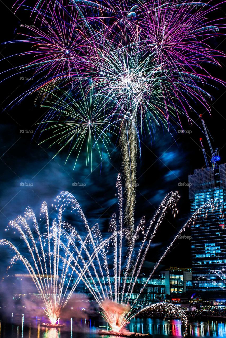 Low angle view of firework display at night