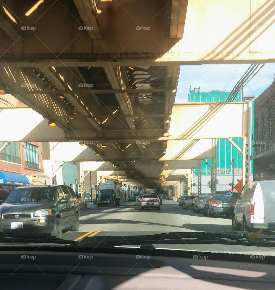 city driving under a bridge, cars commuting in the city, Chicago driving, double layer traffic