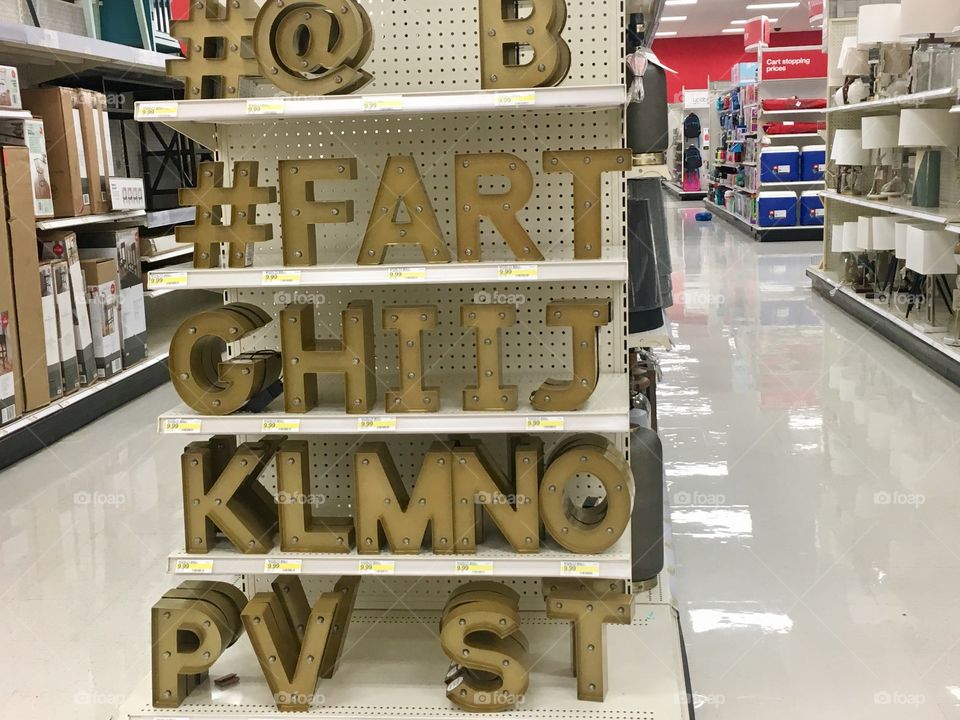 Funny store display with oversized gold letter