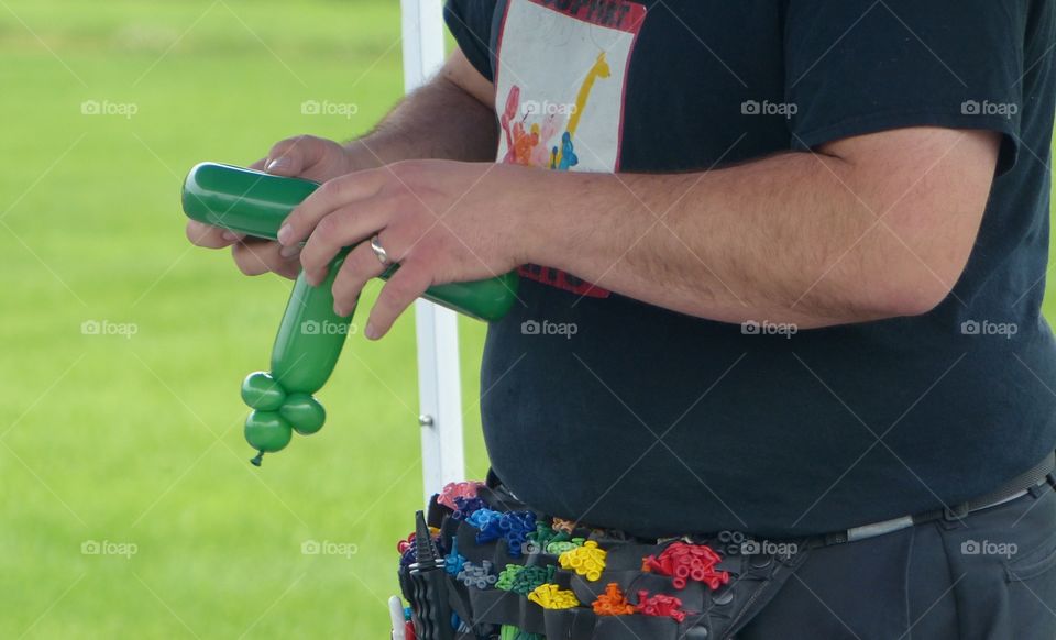 Man making balloon animals and toys