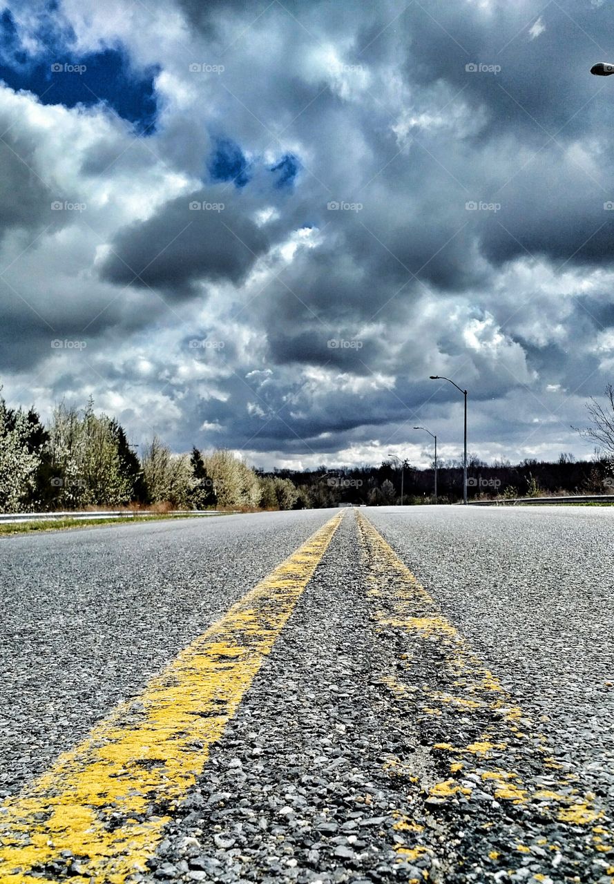 Dark Storm Clouds over Empty Two Lane Road