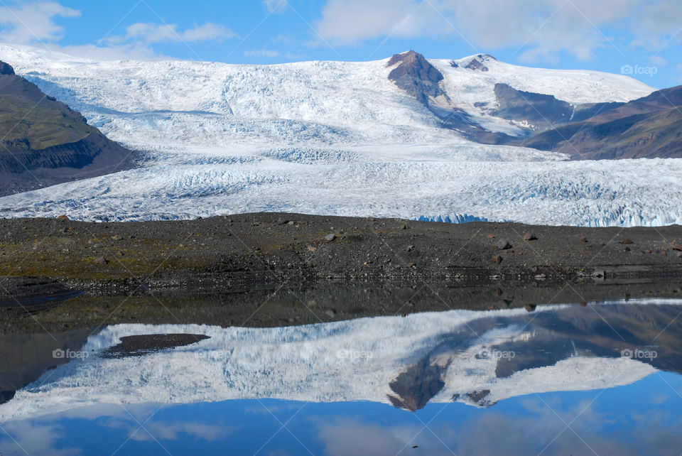 The reflection of a glacier in a glacial lake, Iceland.