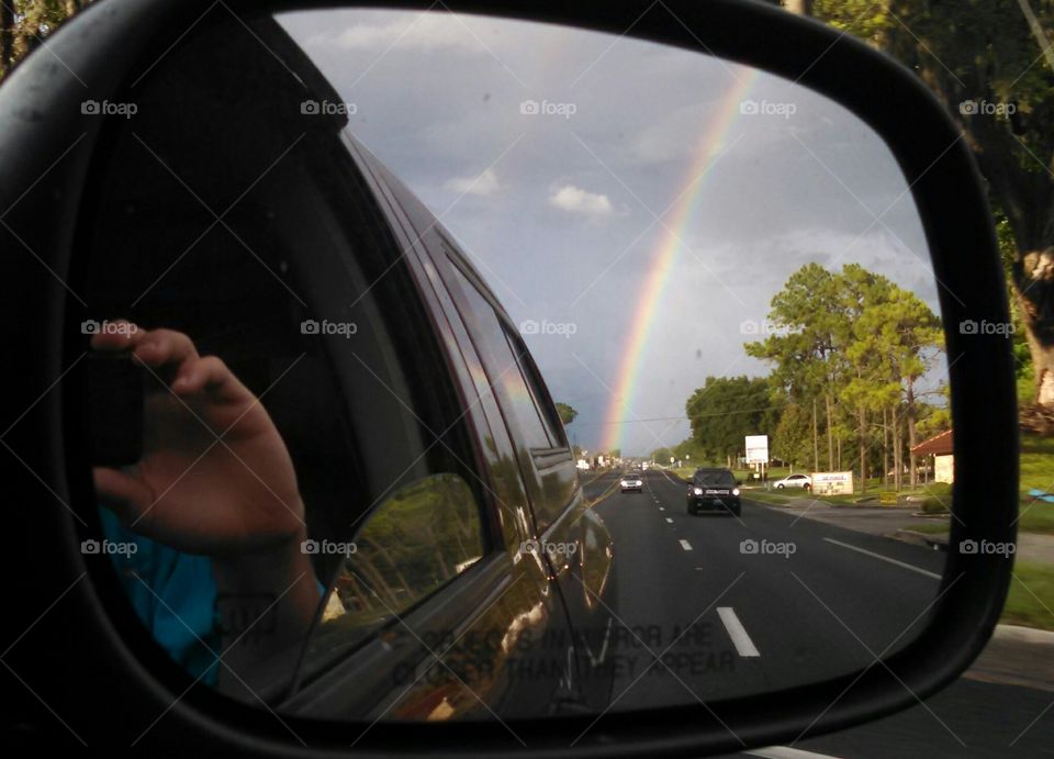 mirror rainbow. driving down the street and looked in the mirror to discover this beautiful image