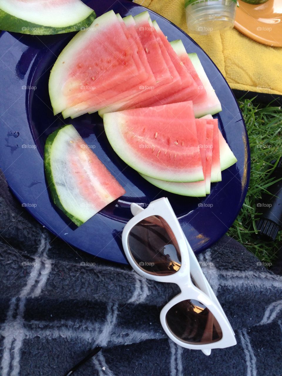 Summer Scene. Summer is watermelon wedges and white sunglasses on the grass.