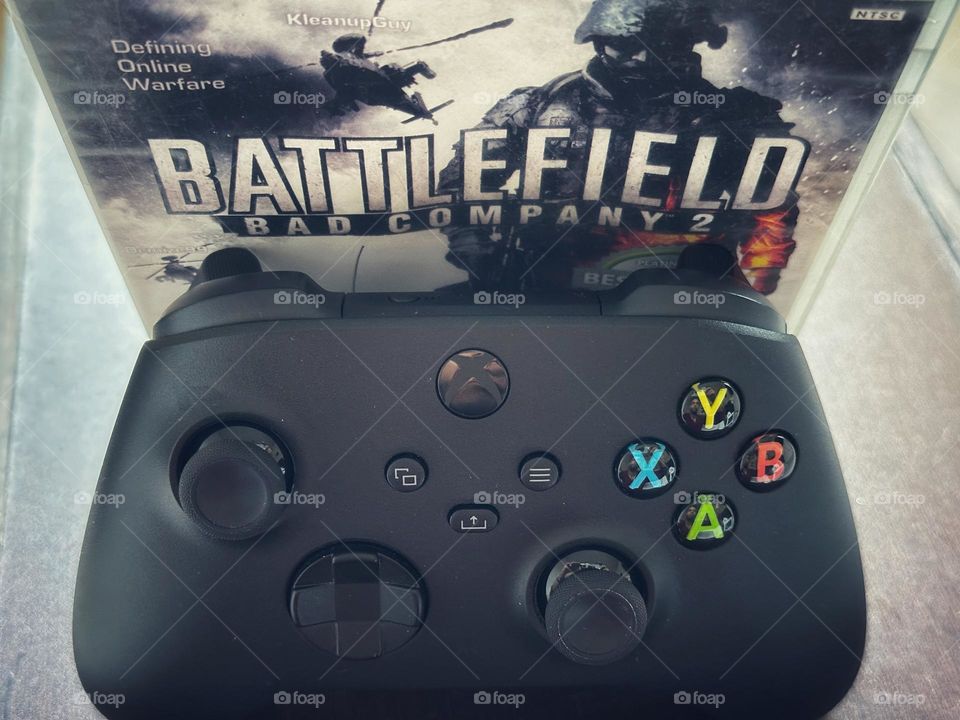 Battlefield Videogame box behind of a Xbox controller captured from up angle. 