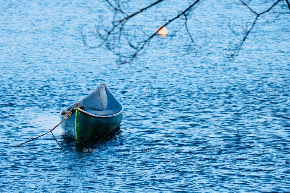 Green boat in a blue ocean