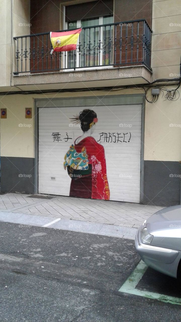 Visual Street Art: Garage door painting of woman walking away from viewer