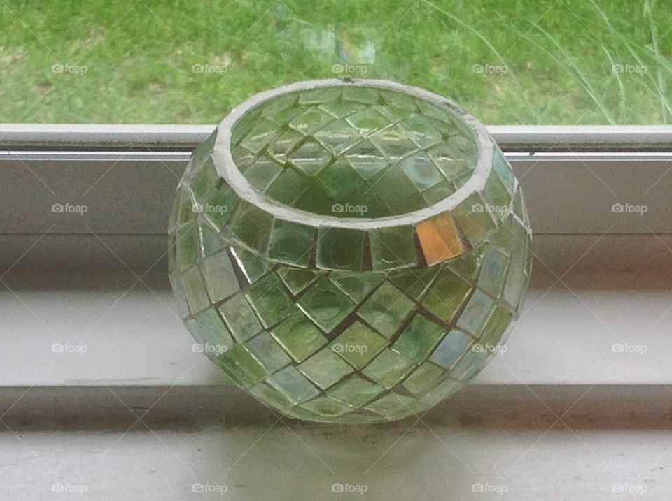 A green glass candle holder.