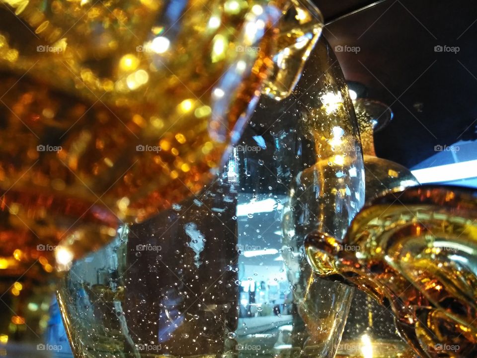 Close up view of the antique Amber glass with the bubble like large glass jar in baxkground