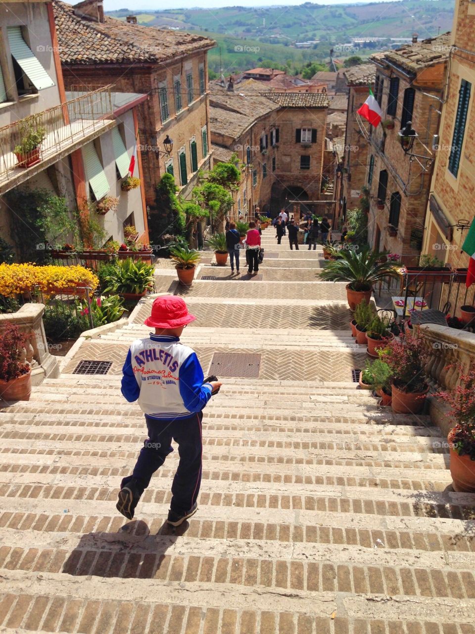 Running off . A child is running off from the top of the village 