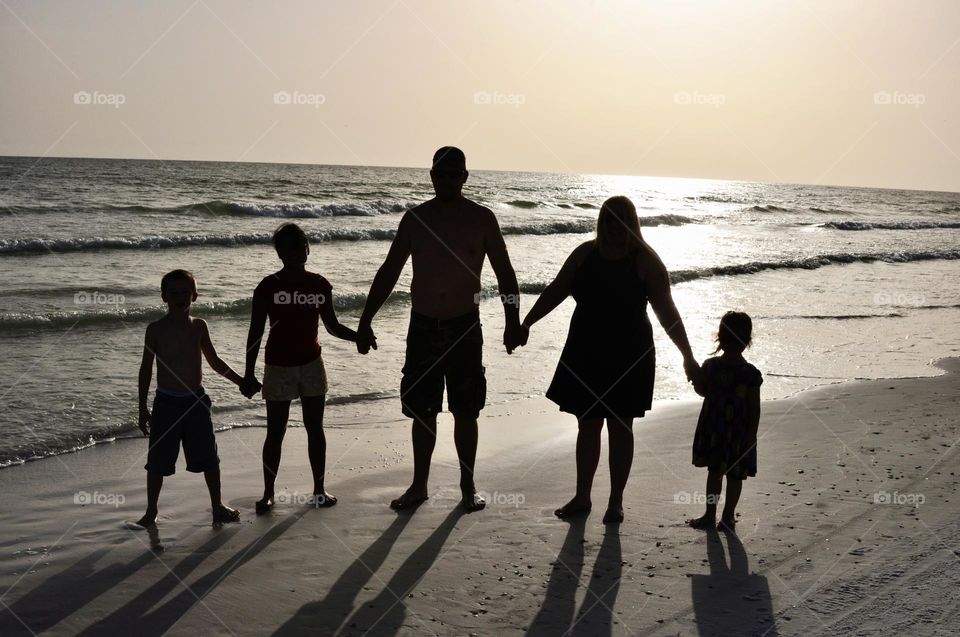 Silhouette of a family on the beach